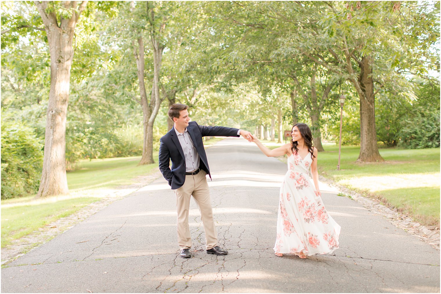 groom twirls bride during NJ engagement photos