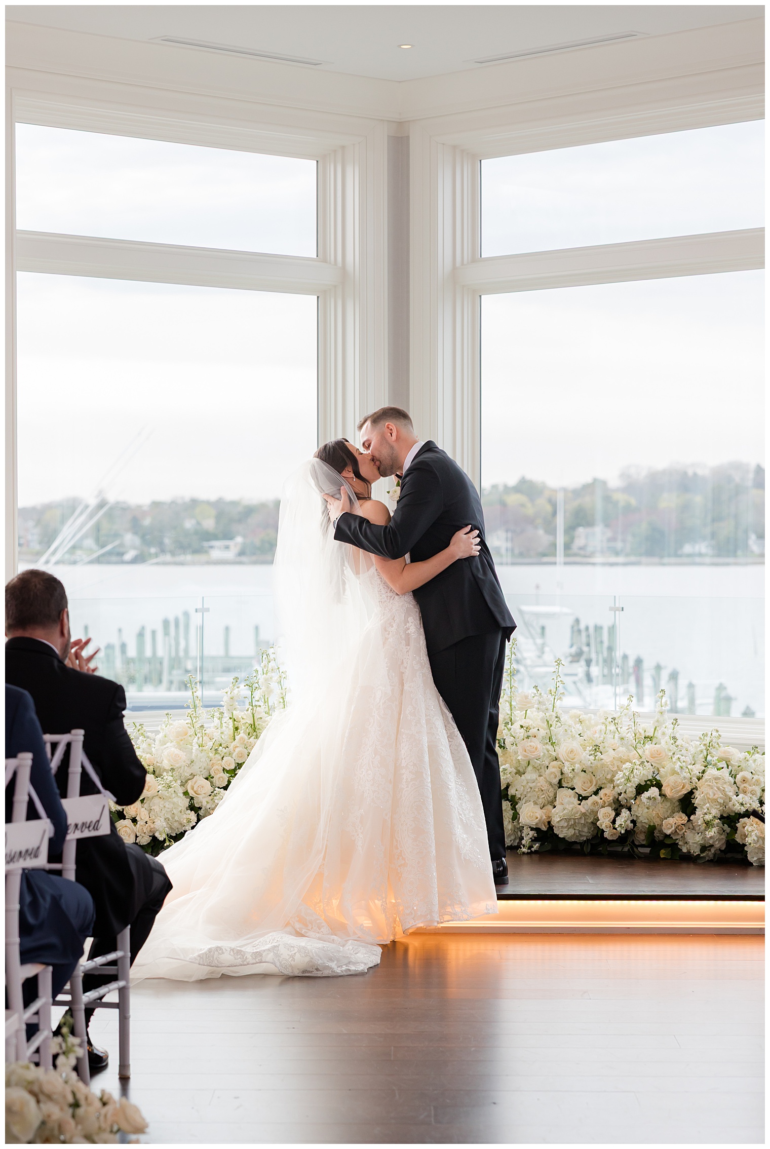 bride and groom kissing at the altar