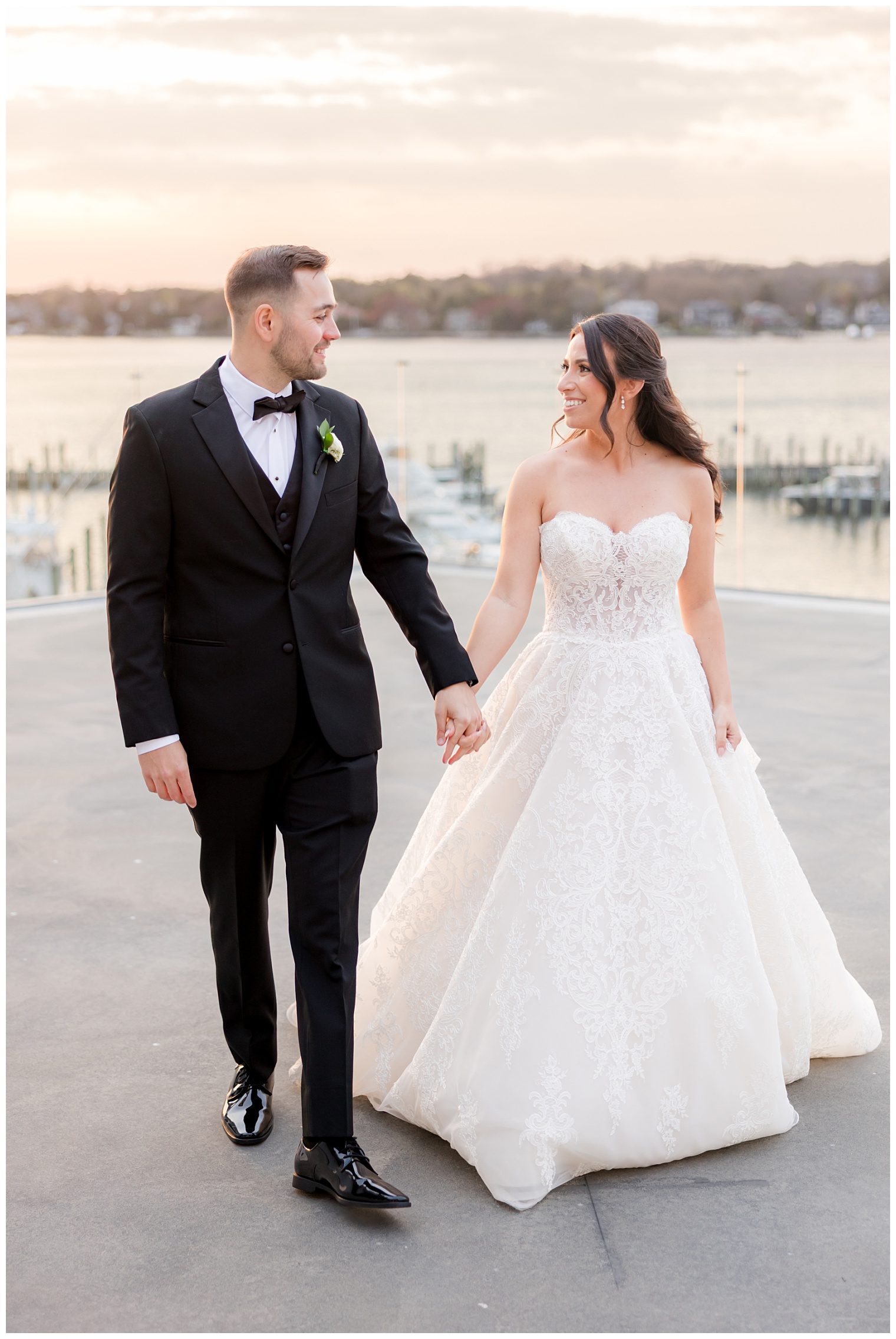 bride and groom walking with the sunset in the background