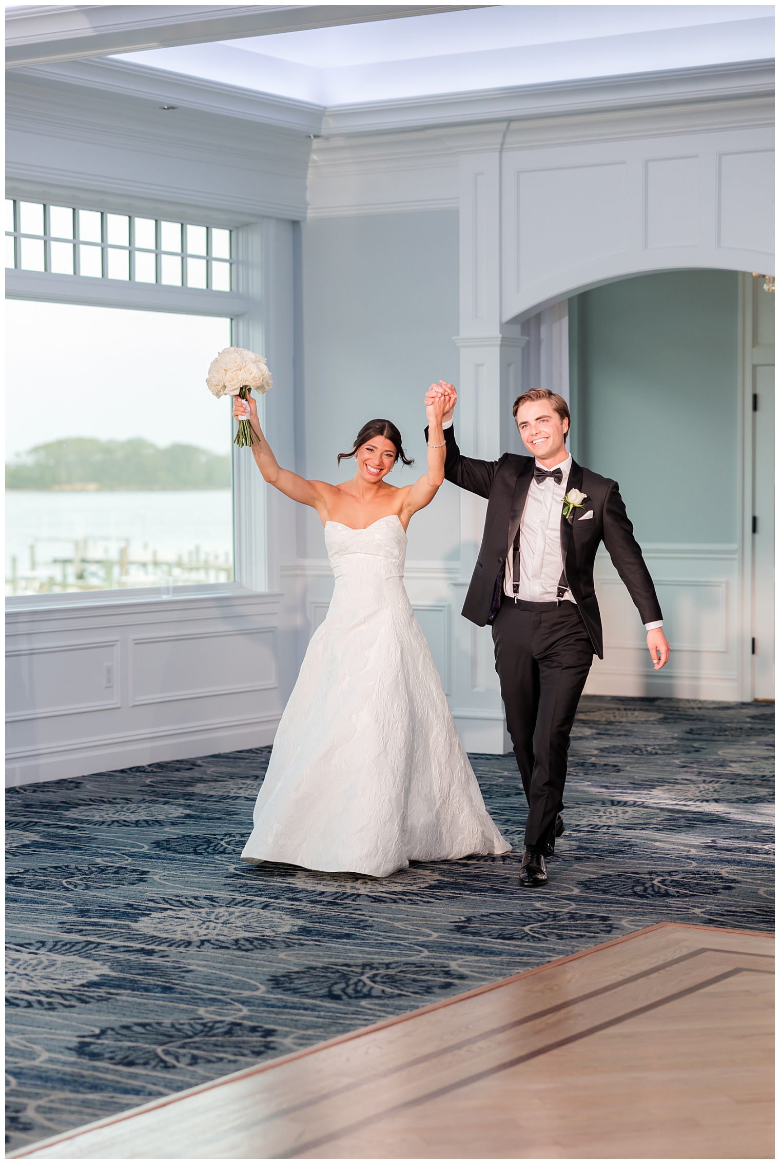 bride and groom entering the ballroom