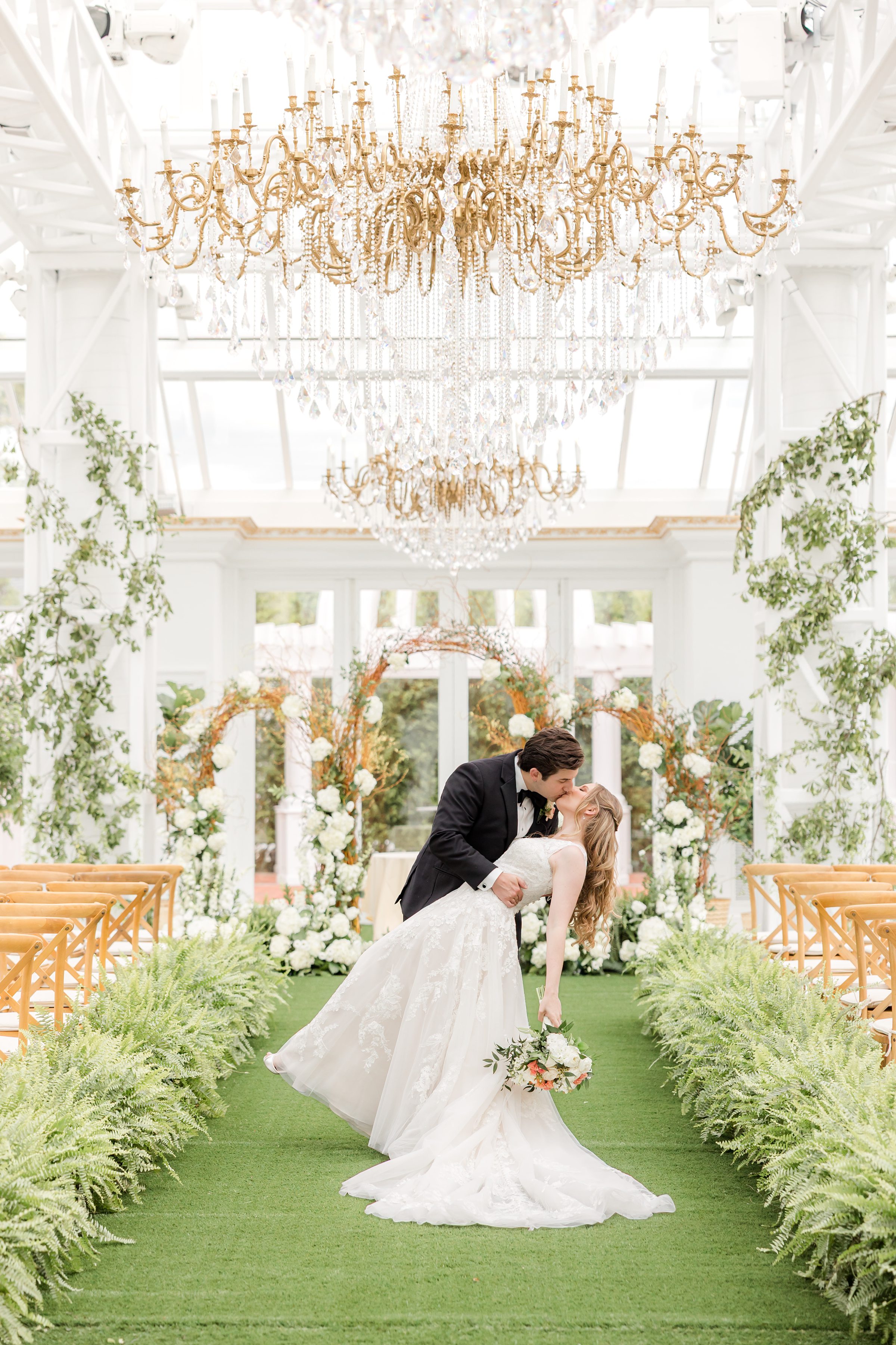 Bride and groom kissing at the empty ceremony space