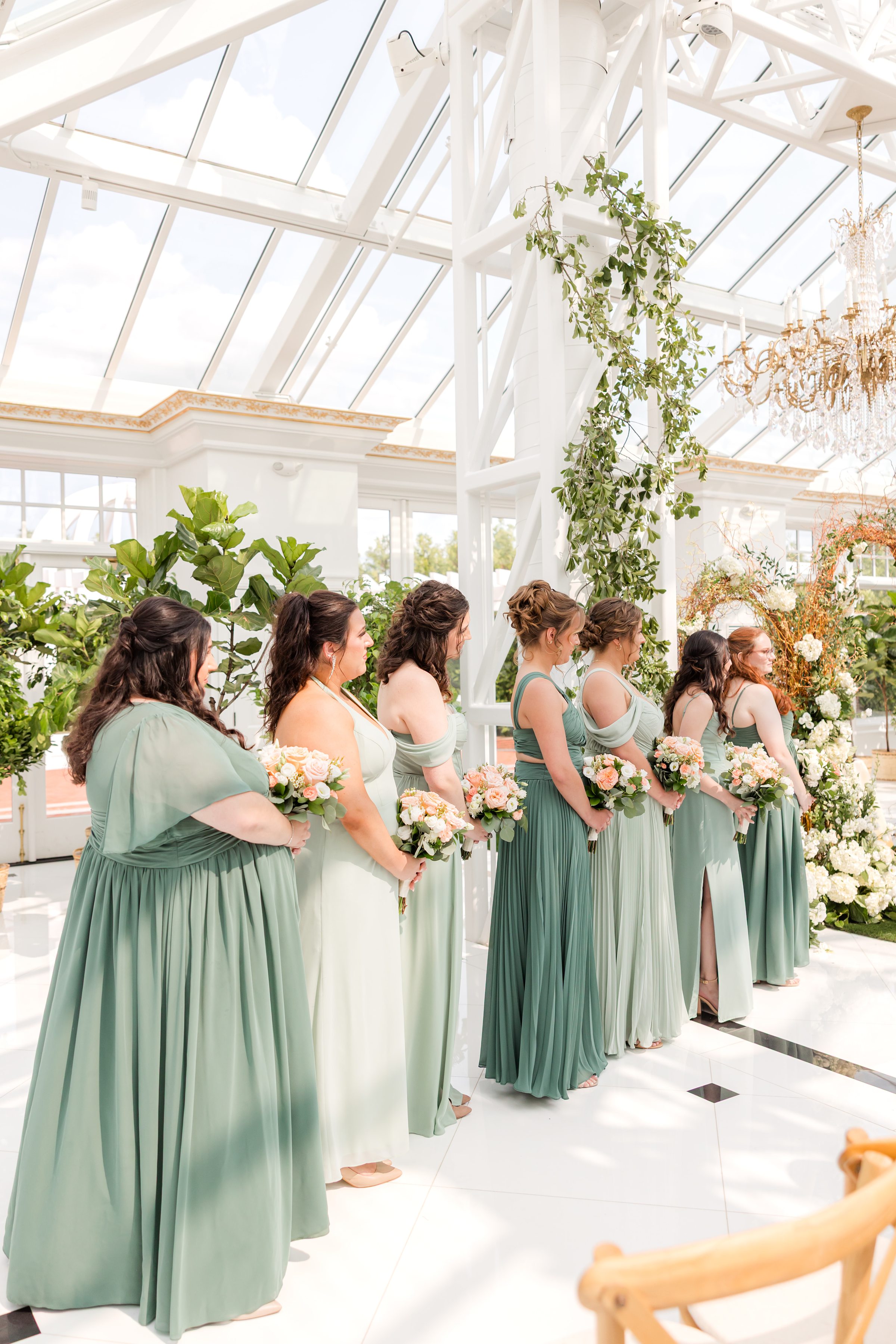 Beautiful shot of the bridesmaids in shades of green dresses
