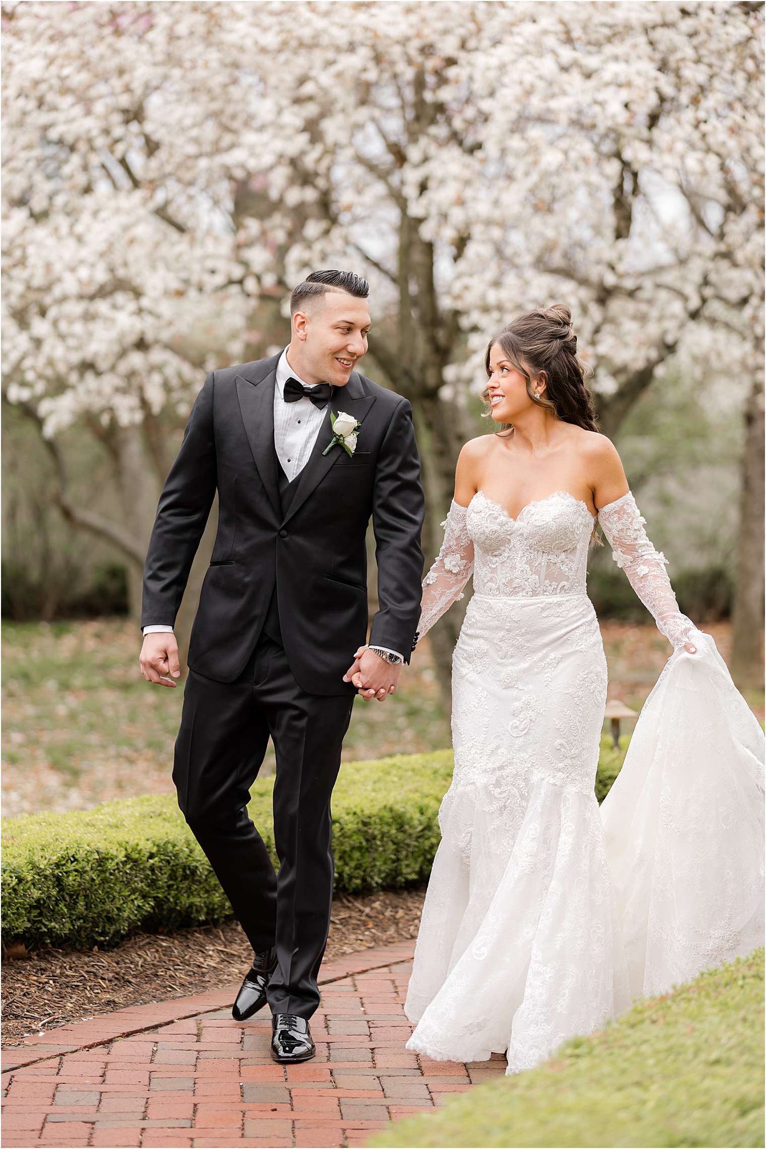 bride and groom during spring rainy day wedding with cherry blossoms at Ashford Estate in Allentown NJ