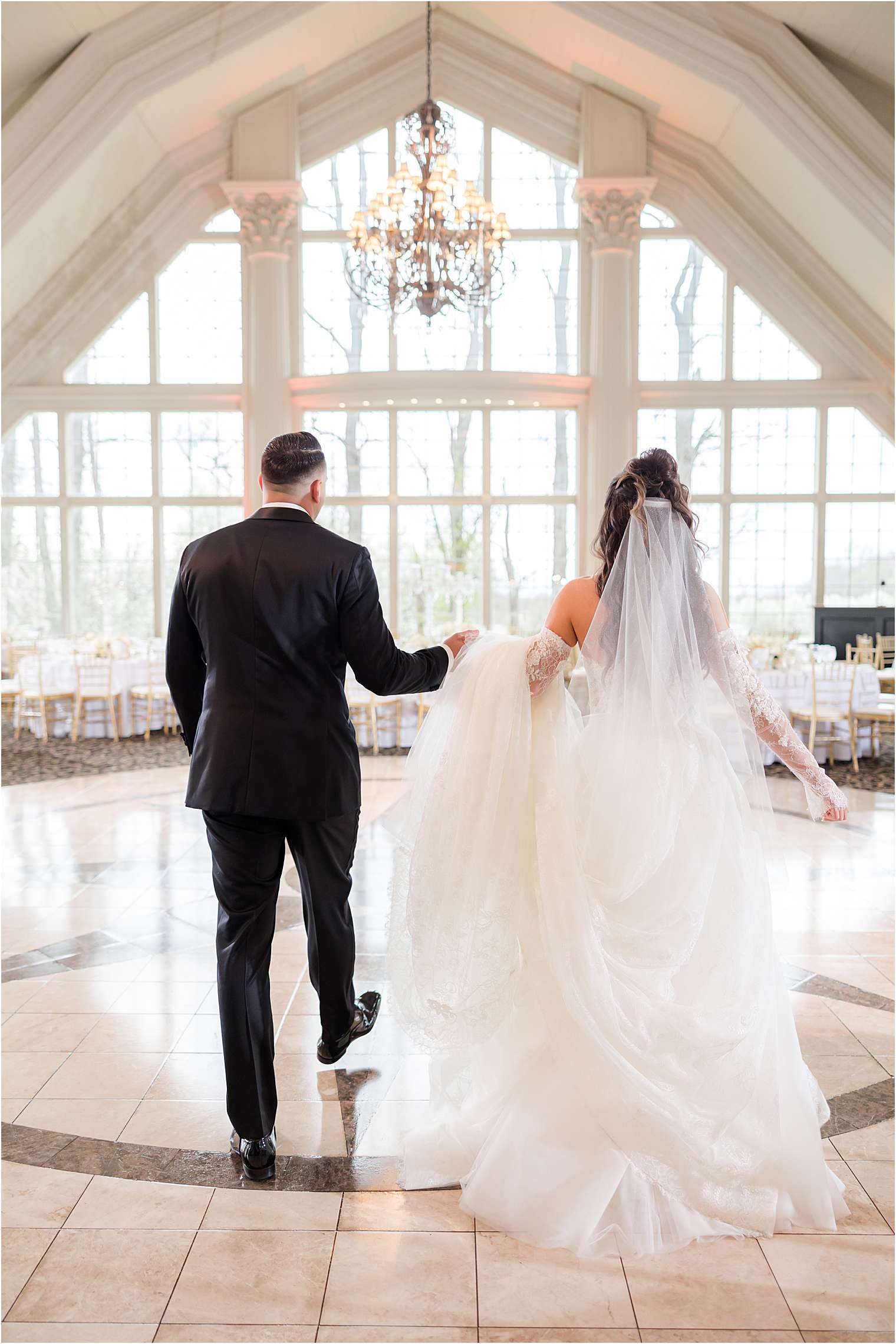bride and groom walking into ballroom reveal at Ashford Estate in Allentown NJ