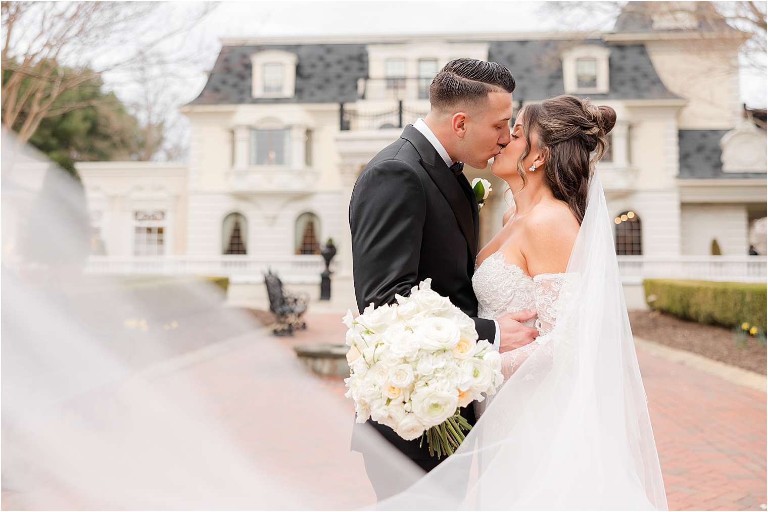 bride and groom kissing outside of Ashford Estate in Allentown NJ