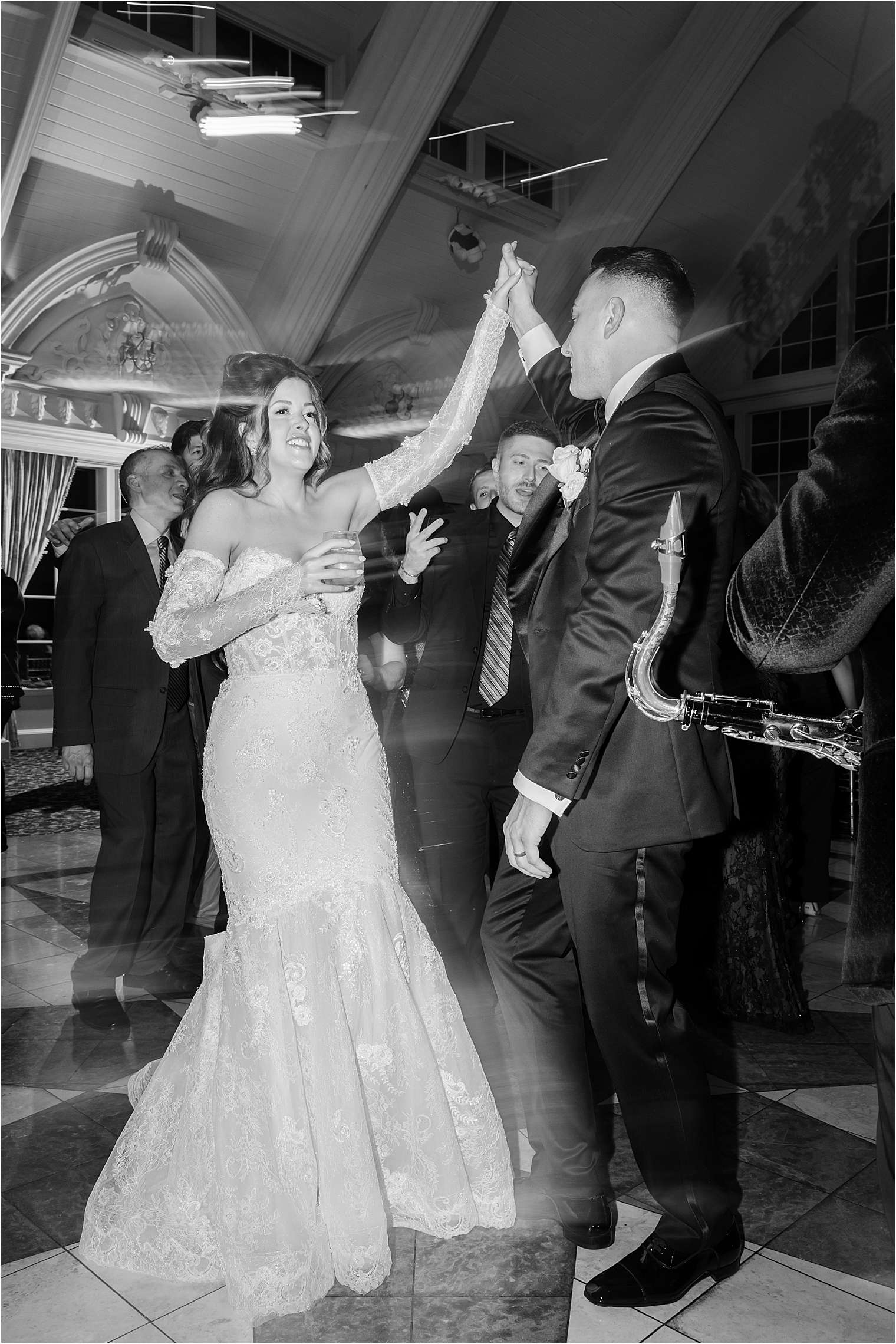 bride and groom dancing on dance floor; photo in black and white