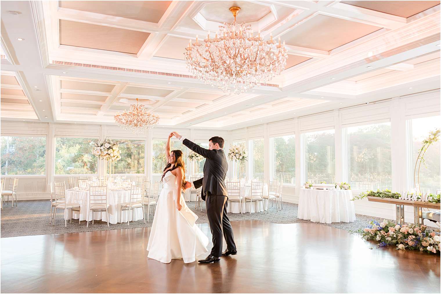 bride and groom dancing alone in the ballroom